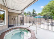Thumbnail 15 of 20 - hot tub and patio at the whispering winds apartments in pearland, tx