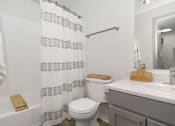 Thumbnail 13 of 13 - a bathroom with a shower curtain and a toilet and a sink
