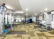 Thumbnail 20 of 22 - a spacious fitness center with weights machines and other exercise equipment