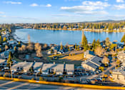 Thumbnail 1 of 41 - A view of a lake surrounded by houses and trees.