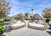 Thumbnail 26 of 38 - two egg shaped chairs with pillows on a rooftop patio