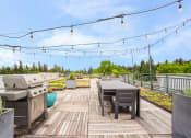 Thumbnail 17 of 20 - the deck is equipped with a grill and a table with chairs
