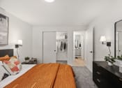 Thumbnail 14 of 24 - a bedroom with a bed and a dresser and a closet
