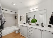Thumbnail 17 of 24 - a bathroom with a large mirror and a sink and a toilet