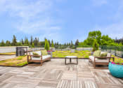 Thumbnail 1 of 20 - a deck with chairs and a table on top of a roof