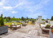 Thumbnail 2 of 20 - a patio with chairs and tables on a deck