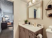 Thumbnail 14 of 33 - a bathroom with a sink and a mirror