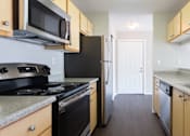 Thumbnail 10 of 25 - a kitchen with a sink and a stove and a refrigerator