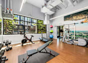 Thumbnail 23 of 38 - a workout room with yoga equipment and a large window with a view of the city