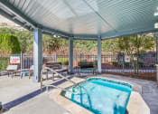 Thumbnail 23 of 24 - the pool is under a covered patio with chairs and a hot tub