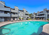 Thumbnail 33 of 33 - A swimming pool in front of apartment buildings.