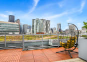 Thumbnail 14 of 27 - a roof terrace with a chair and a view of the city