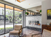 Thumbnail 18 of 38 - the living room has a fireplace and a sliding glass door