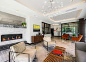 Thumbnail 21 of 38 - a living room with a fireplace and chairs