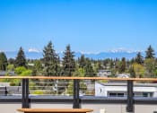 Thumbnail 34 of 53 - a view of the mountains from a balcony with a bench