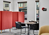 Thumbnail 10 of 32 - A red panelled wall in a room with a business center sign.