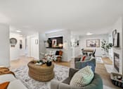 Thumbnail 9 of 24 - a living room with couches and chairs and a fireplace