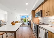 Thumbnail 9 of 53 - a kitchen with wooden cabinets and a white counter top