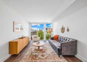 Thumbnail 2 of 53 - a living room with a couch and a rug and sliding glass doors