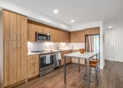 Thumbnail 10 of 53 - a kitchen with wooden cabinets and stainless steel appliances and a white counter top