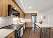 Thumbnail 4 of 53 - a modern kitchen with stainless steel appliances and wooden cabinets