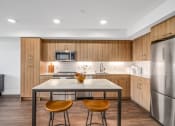 Thumbnail 6 of 53 - a kitchen with wooden cabinets and stainless steel appliances and a marble counter top