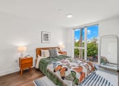 Thumbnail 12 of 53 - a bedroom with a bed and a large window