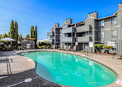 Thumbnail 31 of 33 - A swimming pool in front of a residential building.