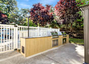 Thumbnail 33 of 38 - A white fence surrounds a small building with a brown roof.