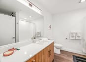 Thumbnail 16 of 53 - a bathroom with a large mirror and a sink and a toilet