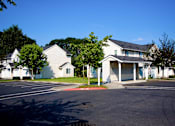 Thumbnail 21 of 25 - a row of white houses in a parking lot