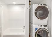 Thumbnail 15 of 53 - a washer and dryer in a laundry room next to a tub