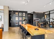 Thumbnail 19 of 53 - a dining room with a wooden table and black chairs