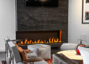 Thumbnail 24 of 53 - a living room with a fireplace and chairs and a table