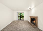 Thumbnail 9 of 26 - A room with a fireplace and a window.