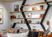 Thumbnail 53 of 53 - a living room with a black shelving unit with shelves and a couch