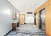 Thumbnail 3 of 42 - a hallway with elevators and doors in an office building