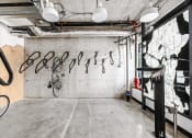 Thumbnail 49 of 53 - a room with bikes hanging on the wall and a map on a wall