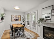 Thumbnail 8 of 24 - A dining room with a table and chairs.