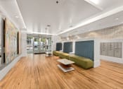 Thumbnail 19 of 27 - a lobby of a building with couches and a table