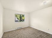 Thumbnail 8 of 26 - A room with a window and a carpeted floor.