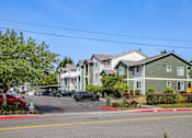 Thumbnail 2 of 34 - A row of houses with cars parked in front.