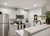 Thumbnail 6 of 24 - a kitchen with stainless steel appliances and white cabinets