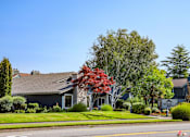 Thumbnail 30 of 33 - A house with a grey roof and a sign that says "Ranchers" in front of it.