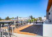Thumbnail 39 of 53 - the deck of the bar area of a restaurant with tables and stools on it