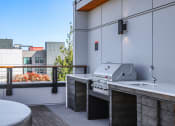 Thumbnail 43 of 53 - a kitchen with a grill and a sink on a balcony