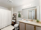 Thumbnail 4 of 29 - a bathroom with a toilet sink and mirror and a shower