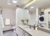 Thumbnail 15 of 33 - a bathroom with a sink and a toilet and a washing machine