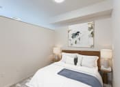 Thumbnail 20 of 33 - a bedroom with a white bed and a painting on the wall