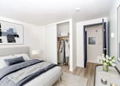 Thumbnail 3 of 13 - a bedroom with a bed and a closet